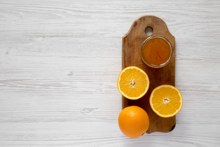 Homemade orange marmelade on rustic board on a white wooden surface, overhead view. Flat lay, overhead, from above. の写真素材