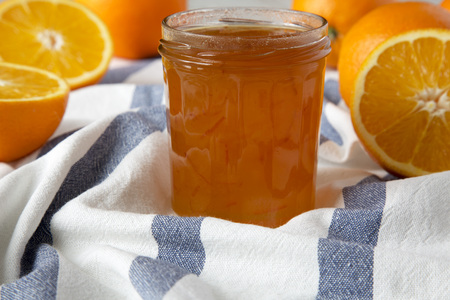 Homemade orange marmelade in glass jar, side view. Closeup.の写真素材