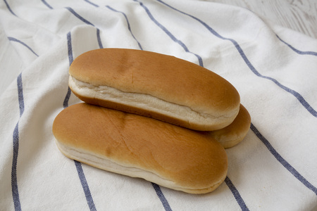 Hot dog buns on cloth, side view. Close-up.