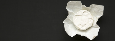 Cheese camembert or brie on black background. Milk production. Top view. Flat lay. Copy space.の写真素材