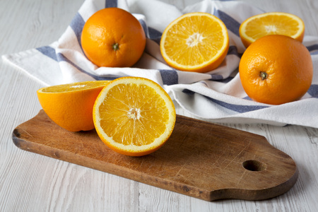 Halved and whole oranges, side view. Close-up.