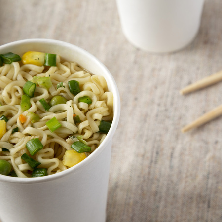 Tasty instant ramen noodles with beef flavoring in paper cups, low angle view. Closeup.の写真素材