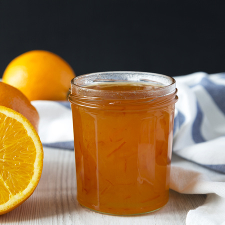 Homemade orange marmelade in glass jar, side view. Close-up.の写真素材