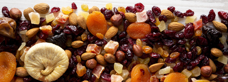 Dried fruits and nut mix on a white wooden surface, top view. Overhead, from above, flat lay.の写真素材