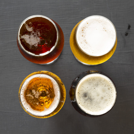 Assorted beers on a black background, top view. Overhead, from above. の写真素材