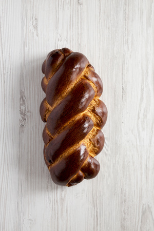 Homemade jewish challah bread on a white wooden background, view from above. Overhead, top view,...