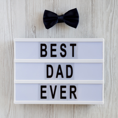 'Best dad ever' words on a lightbox over white wooden background, top view. Overhead, from above, flat lay. Father's day concept.の写真素材