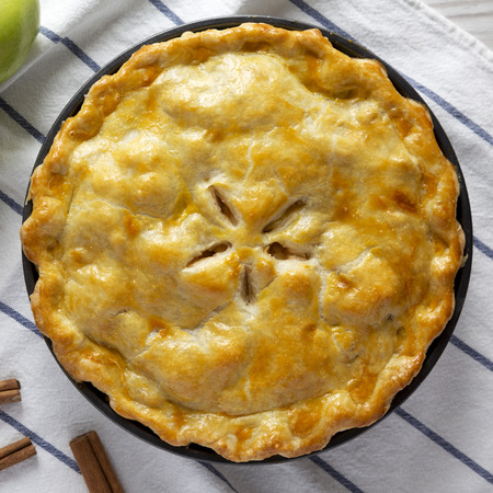 Homemade apple pie on cloth, overhead view. Flat lay, top view, from above. Close-up.の写真素材