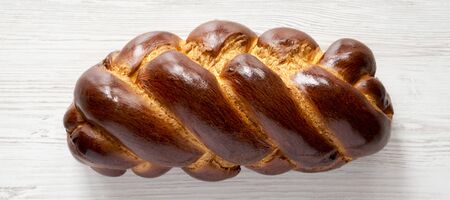 Homemade jewish challah bread on a white wooden table, overhead view. Top view, from above, flat...