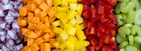 Top view, chopped fresh vegetables (carrot, celery, red onion, peppers) arranged on a cutting board. Overhead view, from above, flat lay.の写真素材