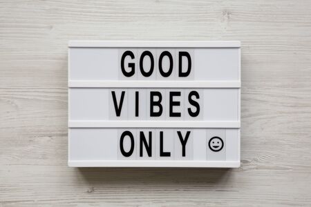 'Good vibes only' words on a modern board on a white wooden surface, top view. From above, overhead, flat lay.の写真素材