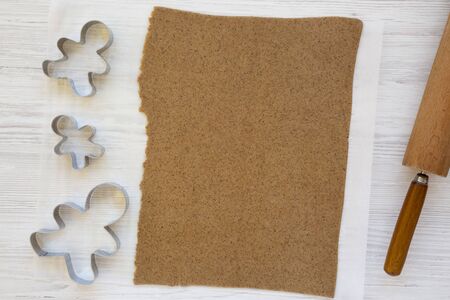 Homemade raw dough for cooking Christmas cookies on a white wooden background, top view. Flat lay,...
