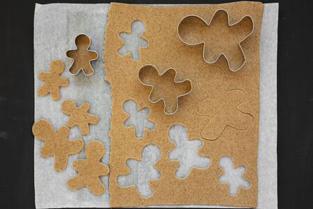 Homemade raw dough for cooking Christmas cookies on a black background, top view. Flat lay,...