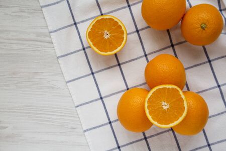 Fresh ripe organic oranges on a white wooden background, top view. Flat lay, overhead, from above. Copy space.の写真素材
