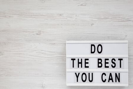 'Do the best you can' words on a lightbox on a white wooden background, top view. Overhead, from above, flat lay. Copy space.の写真素材