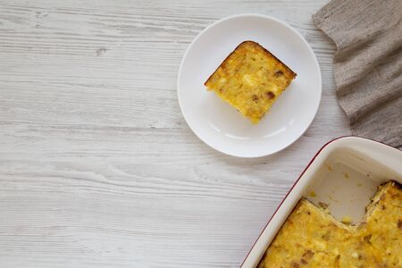 Homemade Cheesy Amish Breakfast Casserole on a white wooden surface, top view. Flat lay, overhead, from above. Copy space.の写真素材