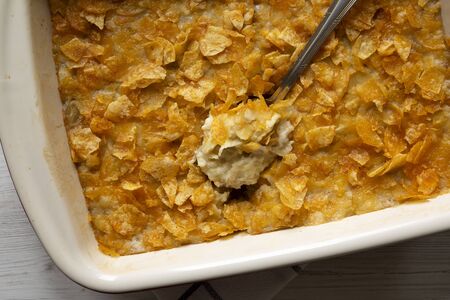 Cheesy Homemade Funeral Potatoes Casserole in a dish, top view. Flat lay, overhead, from above....