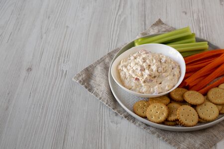 Homemade Pimento Cheese Dip with carrots, celery and crackers, side view. Copy space.の写真素材