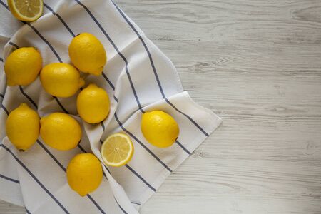 Ripe Yellow Organic Lemons on a white wooden background, overhead view. Flat lay, top view, from above. Copy space.の写真素材