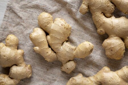 Raw Organic Ginger Root on cloth, top view. Flat lay, from above, overhead.