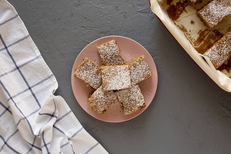 Homemade Tasty Applesauce Cake on a pink plate on a gray background, top view. Flat lay, overhead,...