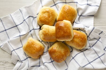 Home-baked Beef Russian Bierocks on a white wooden surface, top view. Flat lay, overhead, from...