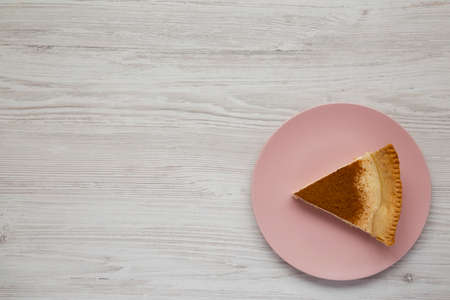 Homemade Sugar Cream Pie on a pink plate on a white wooden background, top view. Flat lay, overhead, from above. Copy space.の写真素材
