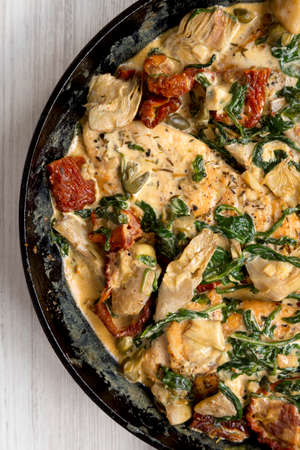 Homemade Creamy Tuscan Chicken in a cast iron pan, top view. Flat lay, overhead, from above. Close-up.の写真素材