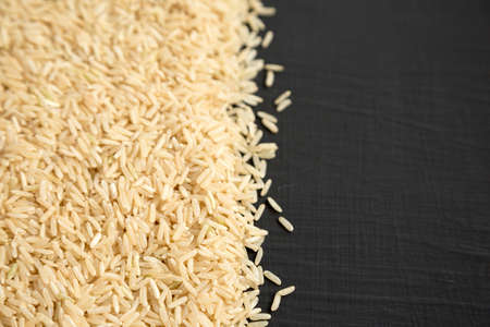Dry Brown Rice background, side view. Copy space.の写真素材