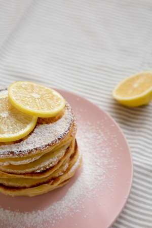 Homemade Lemon Ricotta Pancakes on a pink plate, side view. Copy space.の写真素材