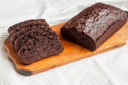 Homemade Chocolate Zucchini Bread on a rustic wooden board, low angle view. Close-up.