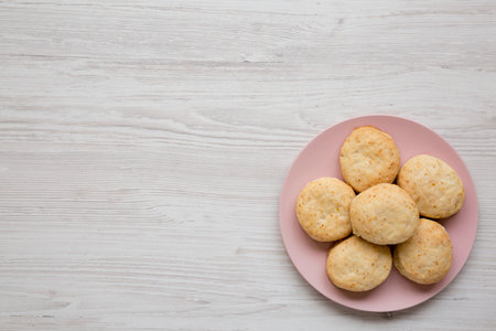 Homemade Flaky Buttermilk Biscuits on a pink plate on a white wooden background, top view. Flat lay, overhead, from above.の写真素材