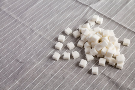 Organic White Sugar Cubes on cloth, low angle view. Copy space.の写真素材
