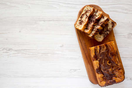 Homemade Chocolate Banana Bread on a rustic wooden board, top view. Flat lay, overhead, from above....