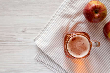 Hard Apple Cider Ale in a Glass Jar Mug on a white wooden background, top view. Flat lay, overhead, from above. Copy space.の写真素材