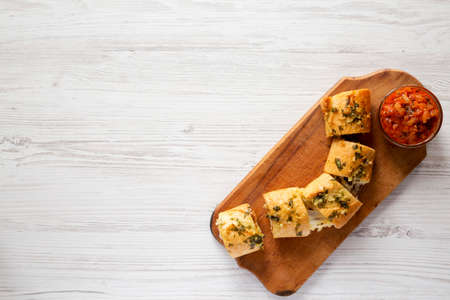 Homemade Chicken Parmesan-Stuffed Garlic Bread on a rustic wooden board on a white wooden table, top view. Overhead, from above, flat lay. Copy space.の写真素材