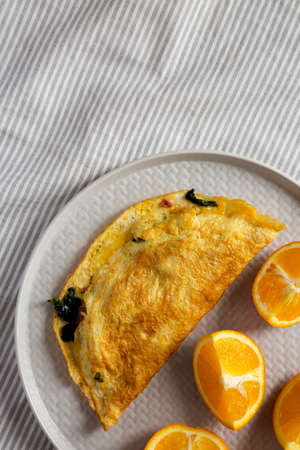 Homemade Bacon Spinach Omelette with Cheddar Cheese, top view. Flat lay, overhead, from above. Copy space.の写真素材