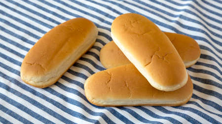 Whole Grain Hot Dog Buns on cloth, side view.
