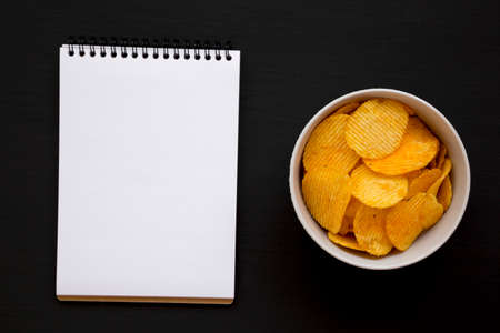 Ruffled Cheese Potato Chips, blank notepad, top view. Flat lay, overhead, from above.