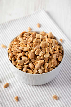 Roasted Salted Shelled Peanuts in a Gray Bowl, side view.