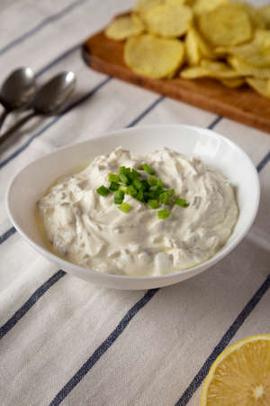 Homemade Clam Dip with Potato Chips, side view.