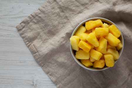 Organic Frozen Pineapple Slices in a Bowl, top view. Flat lay, overhead, from above. Space for text.の写真素材