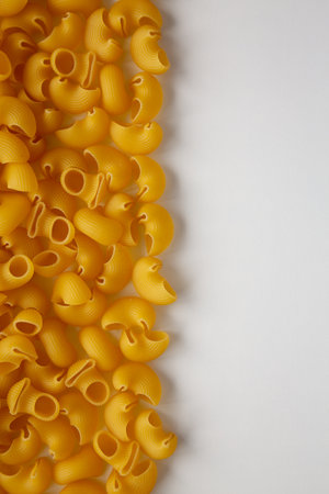 Raw Dry Organic Pipe Rigate Pasta on white surface, top view. Flat lay, overhead, from above. copyspace.の写真素材