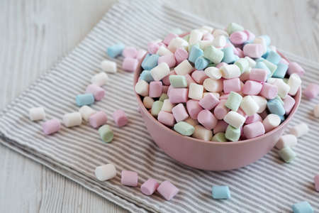 Rainbow Fruity Mini Marshmallows in a Pink Bowl, side view. copyspace.の写真素材