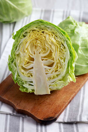 Raw Organic Cabbage on a Rustic Wooden Board, side view. close-up.の写真素材