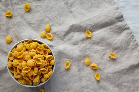 Dry Organic Gnocchi Pasta in a bowl, side view. close-up.