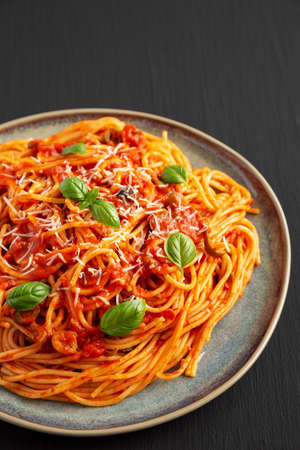 Homemade Spaghetti with Olives and Tomato Sauce on a Plate, side view.の写真素材