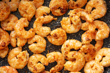 Cooking shrimps on a frypan, top view. close-up.の写真素材