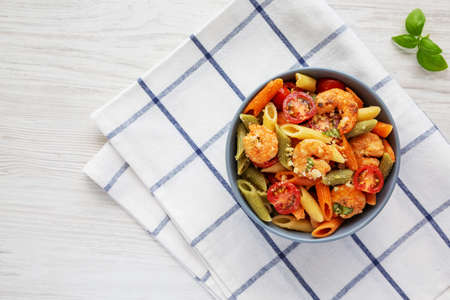 Homemade Tri-Color Penne Salad with Shrimp, Tomato and Basil Bread Crumbs in a Bowl, top view. Flat lay, overhead, from above. Space for text.の写真素材