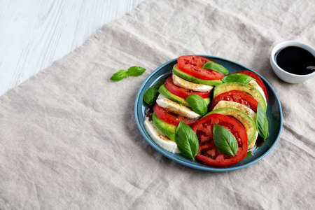 Homemade Organic Avocado Caprese Salad on a Plate, side view. copyspace.の写真素材